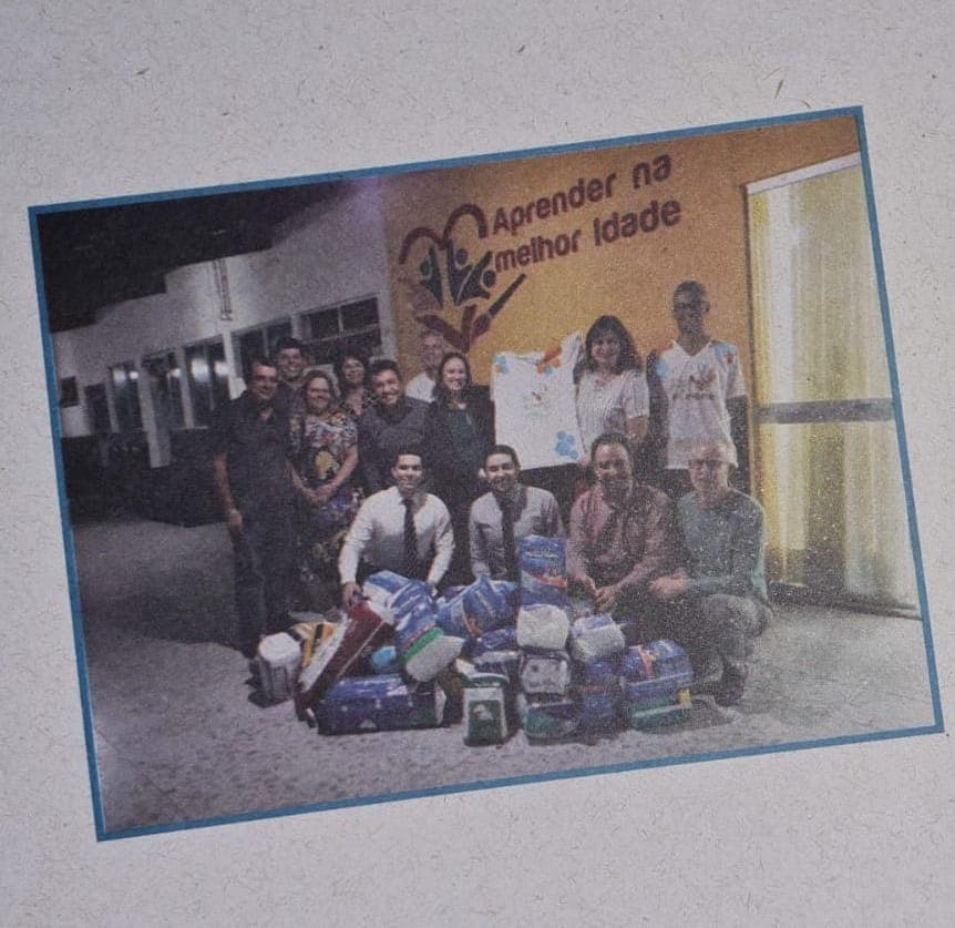 Pessoas reunidas em volta de fraldas adquiridas para doação